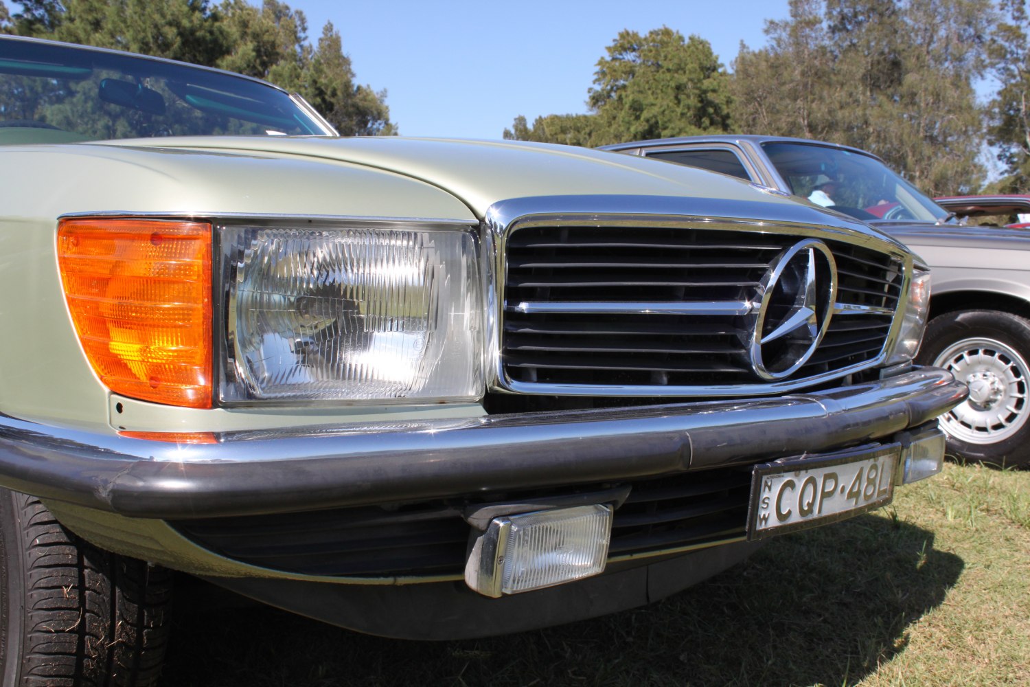 Classic car front grille and headlight with chrome and amber turn signal