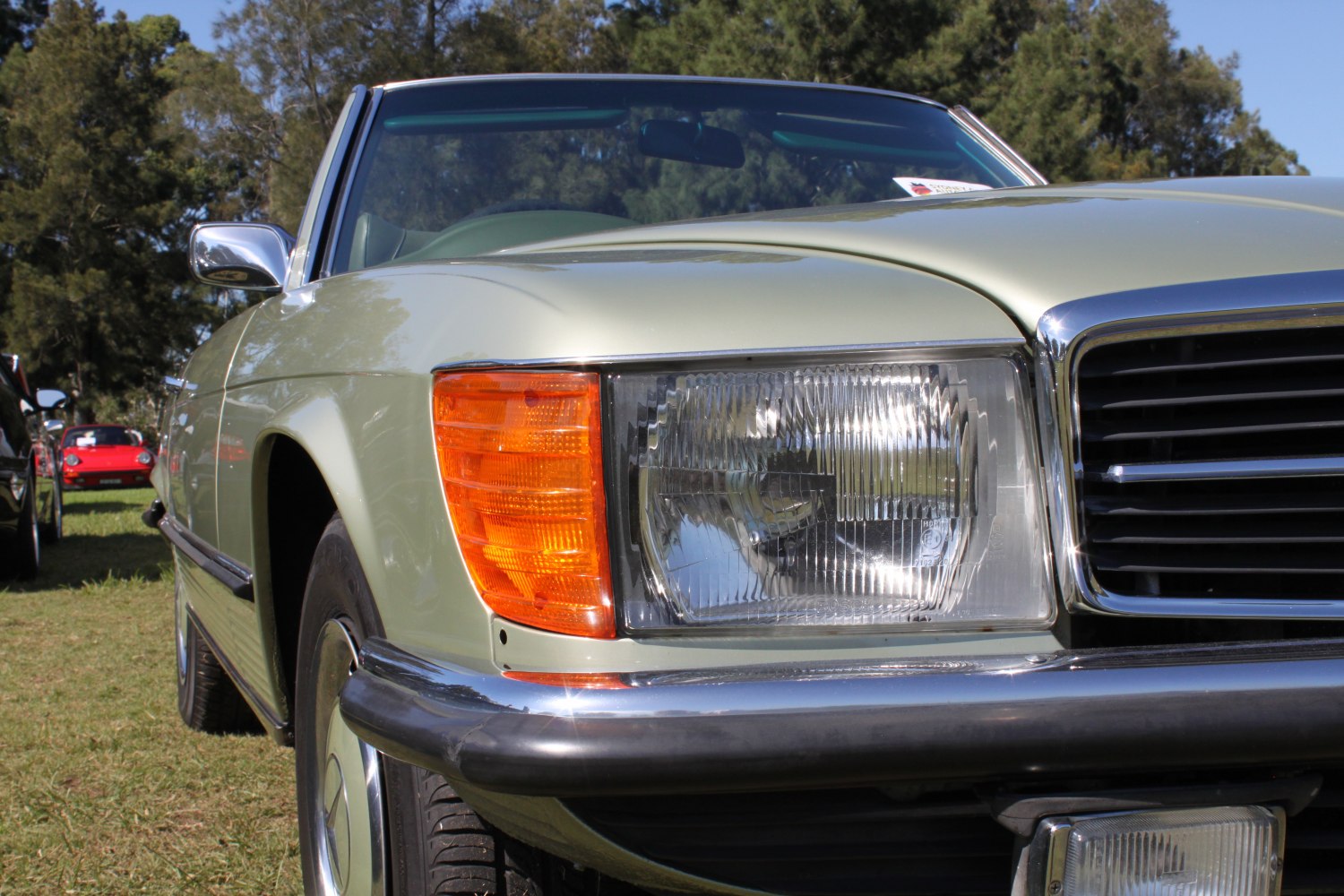 Close-up of vintage car front with headlight and orange indicator