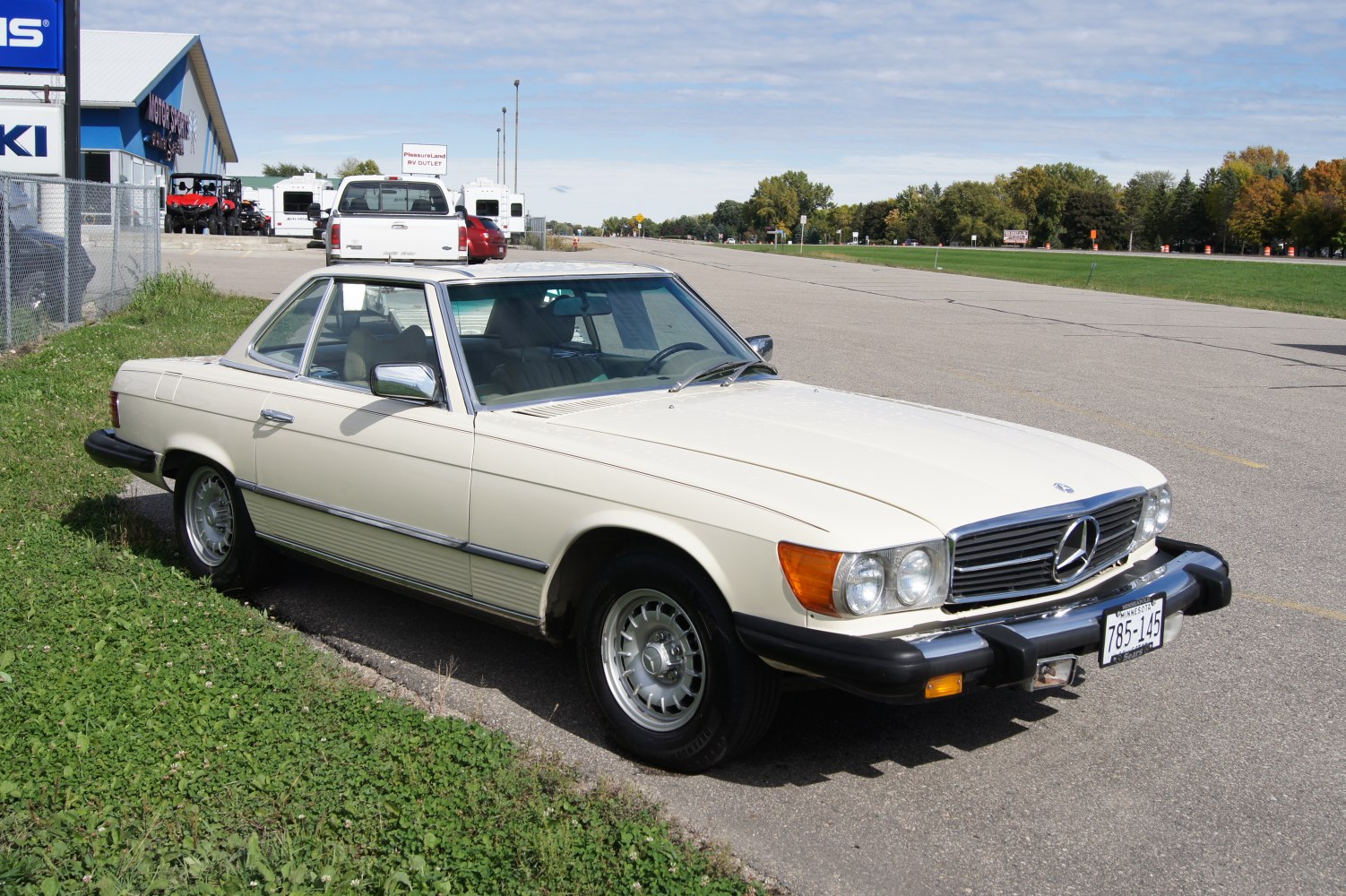 Vintage beige two-door coupe with round headlights and chrome details