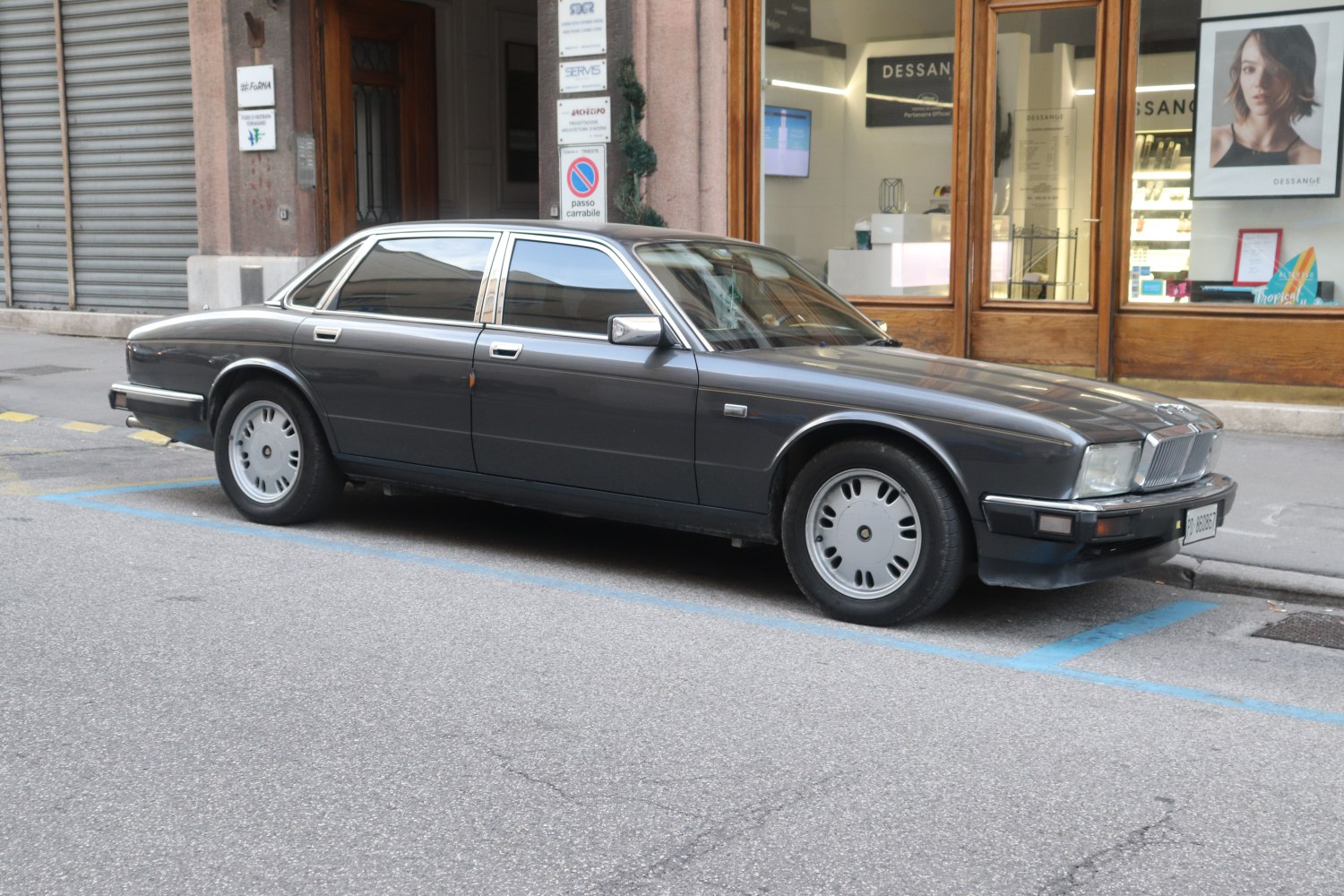 Classic sedan with elegant side profile and distinct vintage wheels