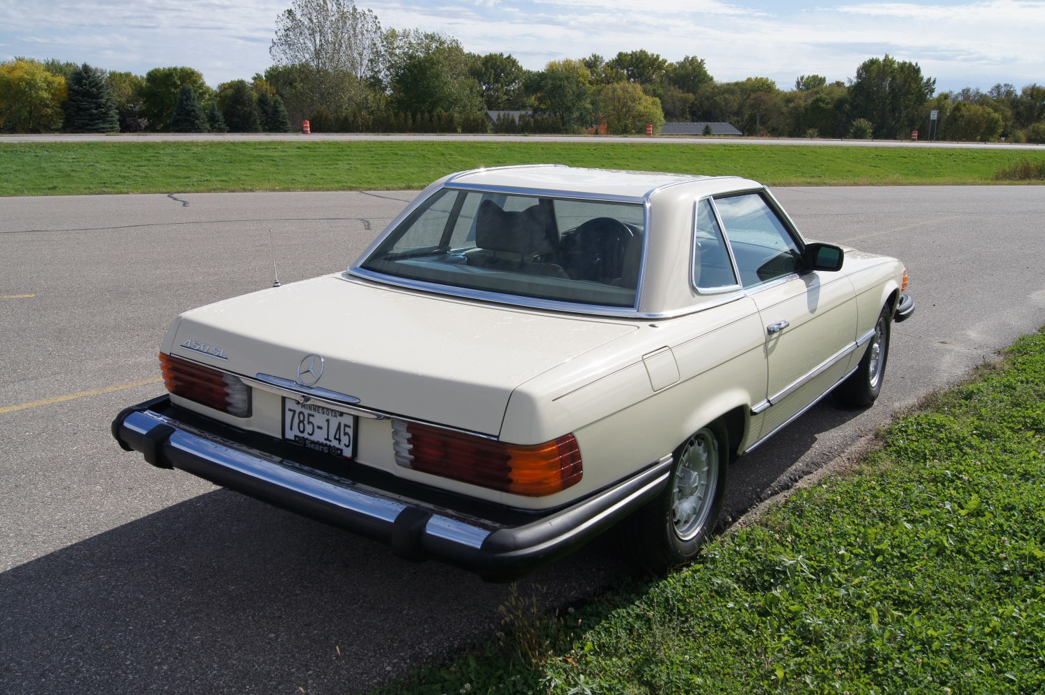 Convertible hardtop with vintage taillights and chrome bumper.