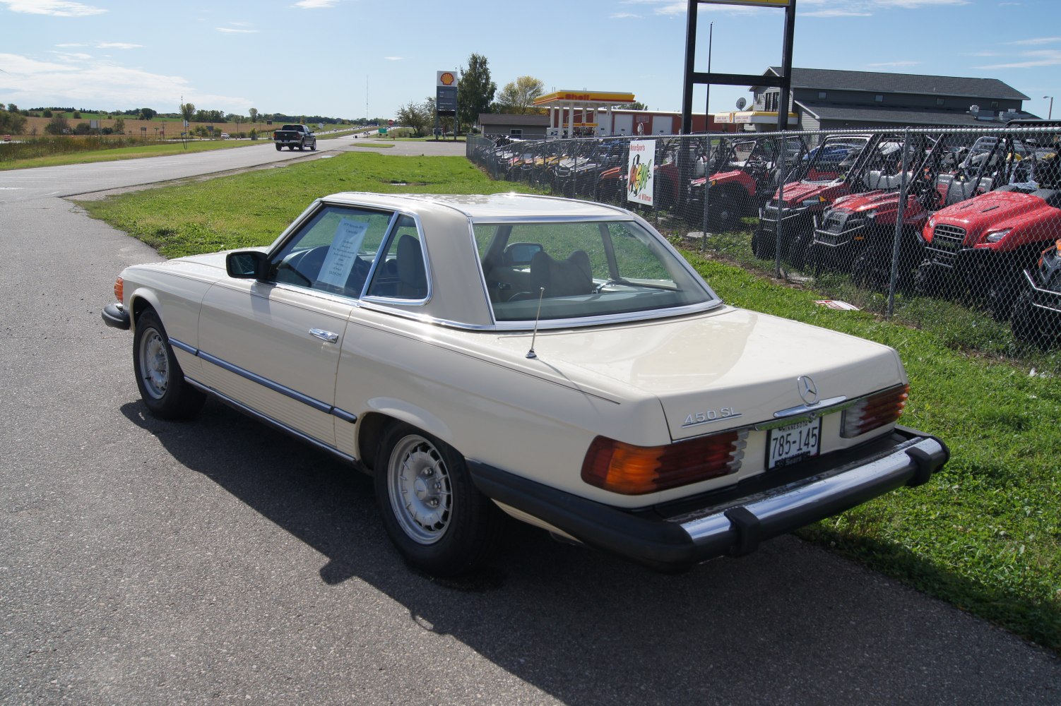 Vintage hardtop coupe with boxy rear and chrome trim under daylight