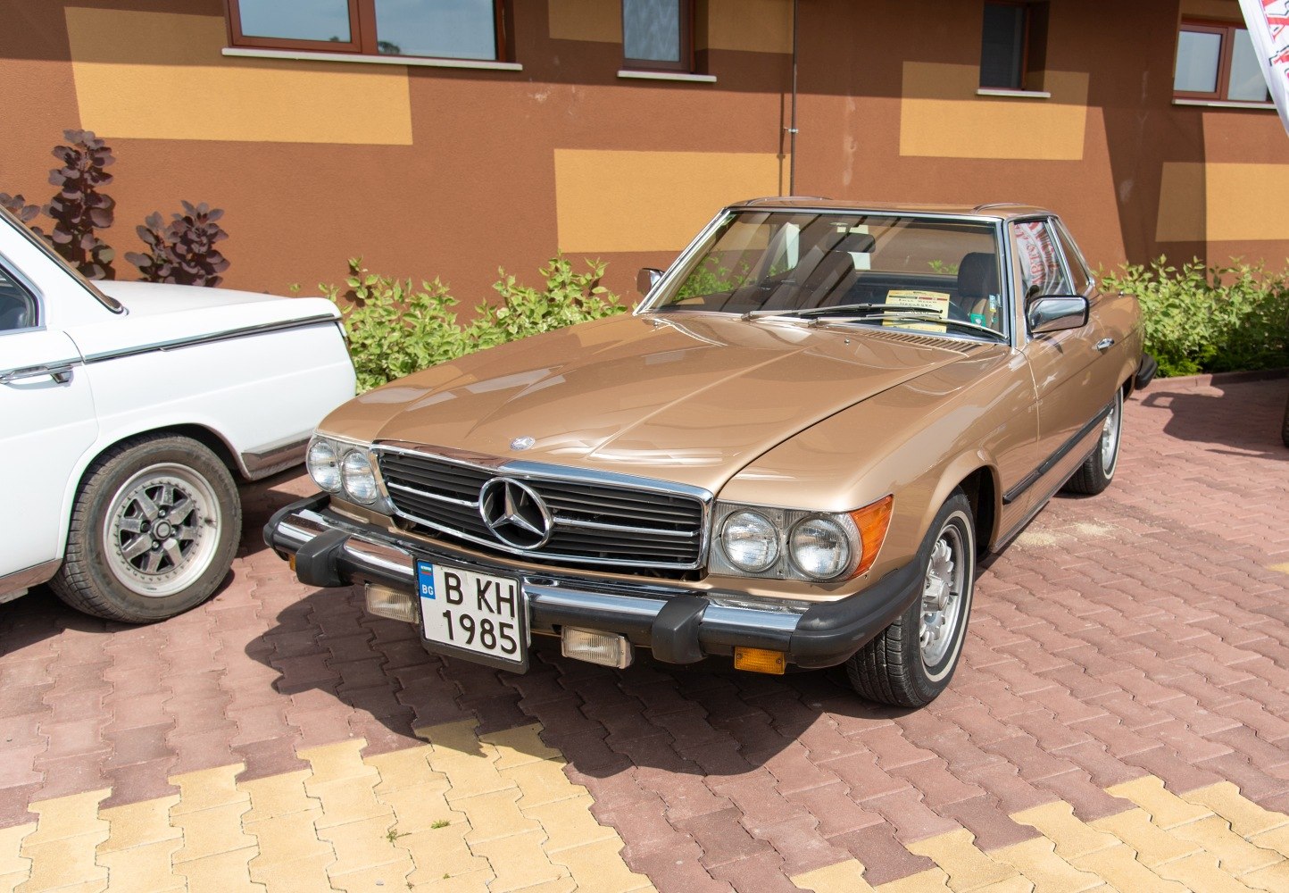 Vintage front grille and dual round headlights of a classic coupe