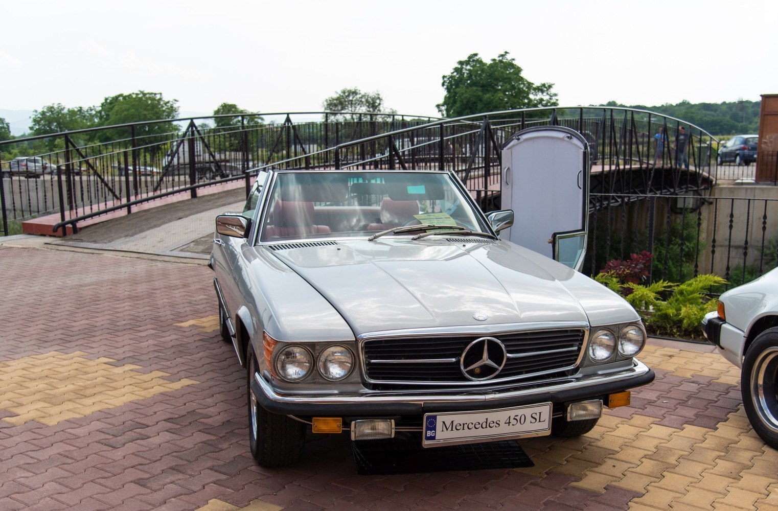 Front view of a classic Mercedes convertible with dual round headlights and chrome grille.