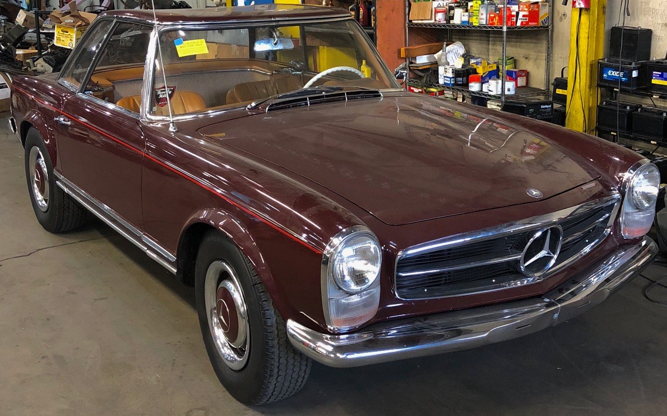 Vintage two-door coupe with round headlights and chrome grille