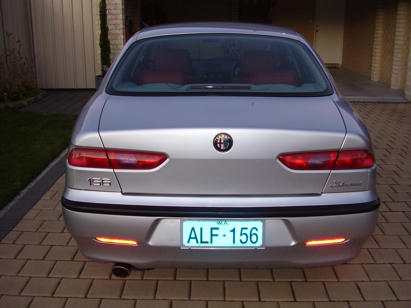 Rear view with tail lights, badges, and exhaust