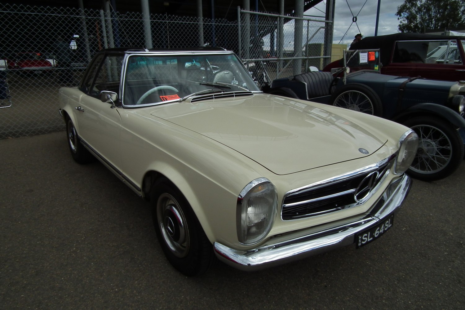 1960s vintage two-door coupe with chrome bumper and round headlights