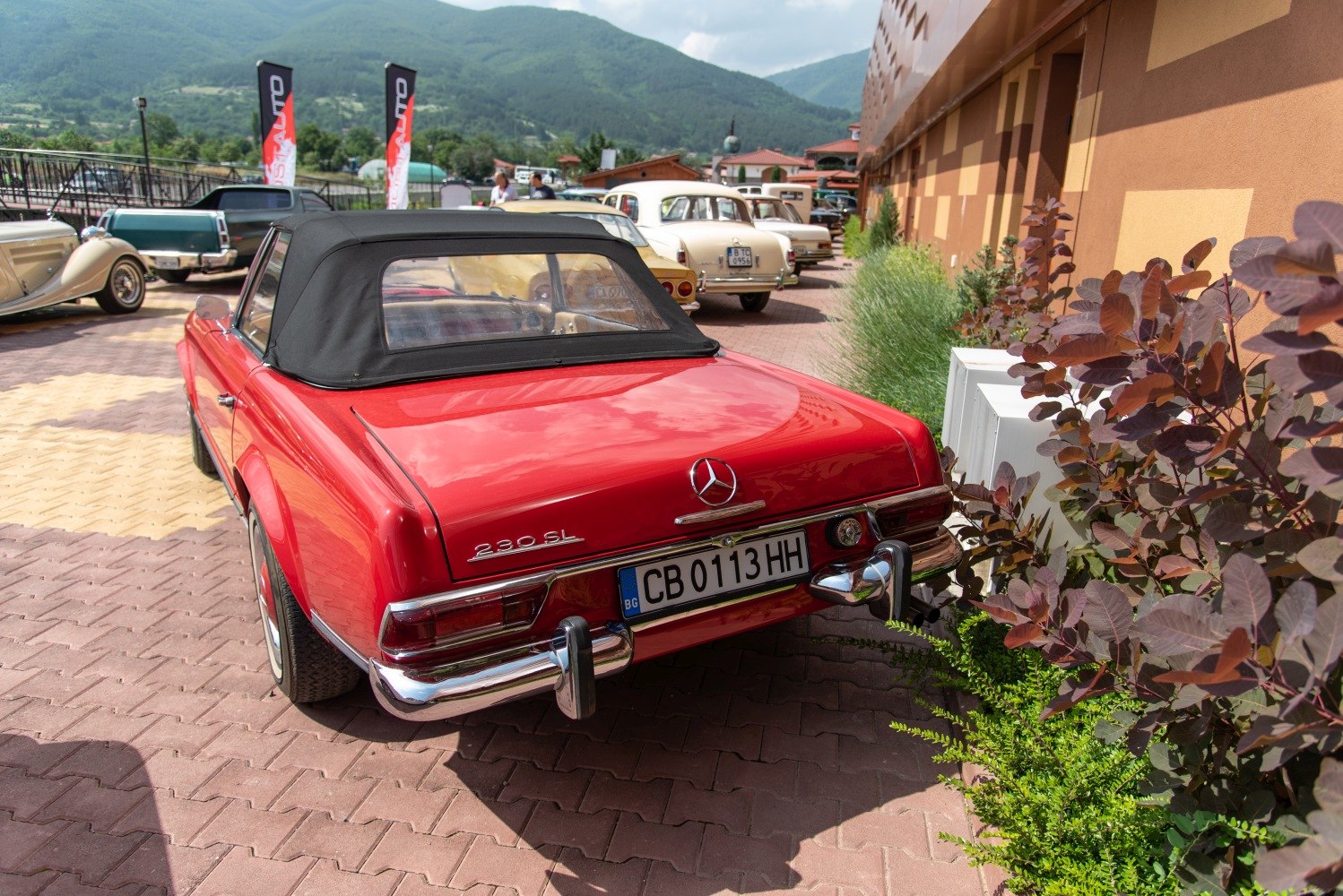 Red convertible rear view with chrome bumper and soft top