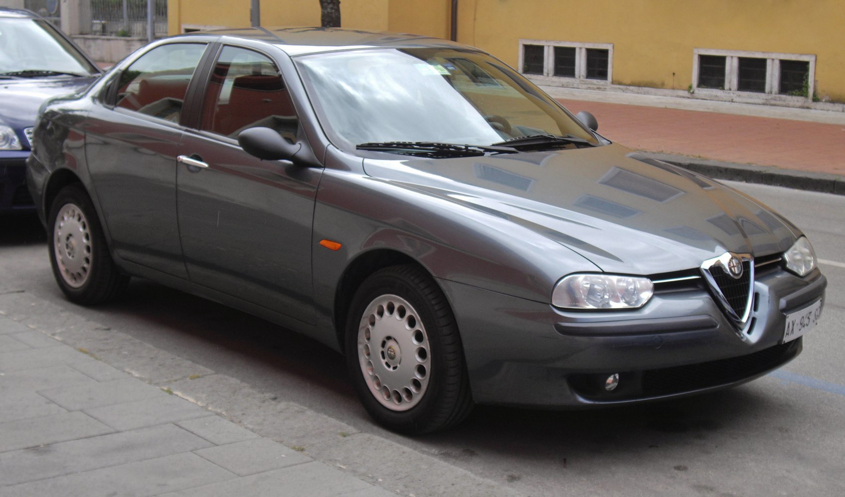 Sleek sedan with triangular grille and round headlights