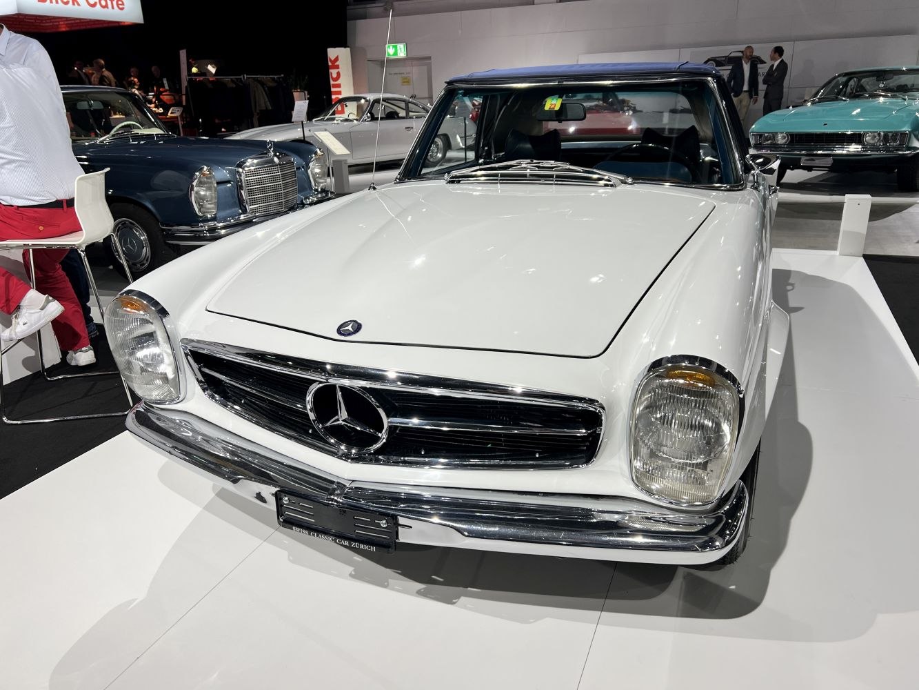 Vintage front view with bonnet, chrome grille, and classic headlights.