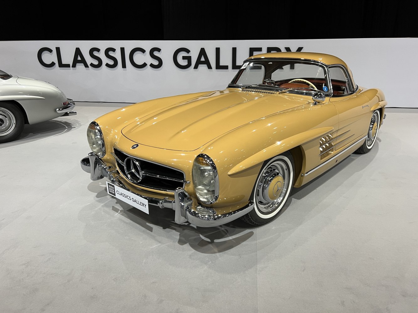 Vintage roadster with distinctive hardtop and classic styling.