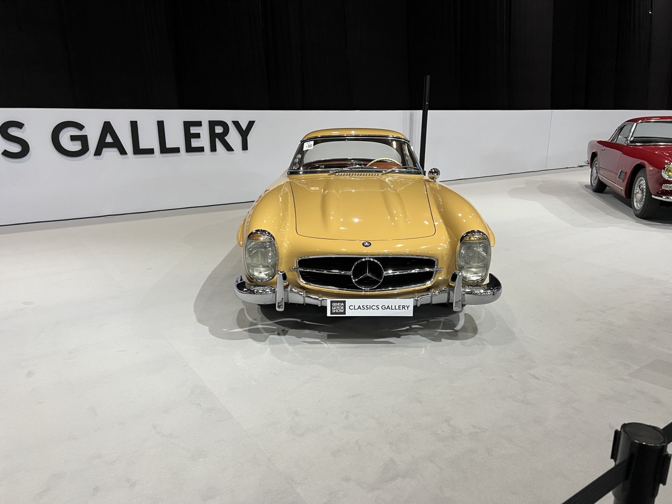 Front view of vintage hardtop roadster with chrome grille and round headlights