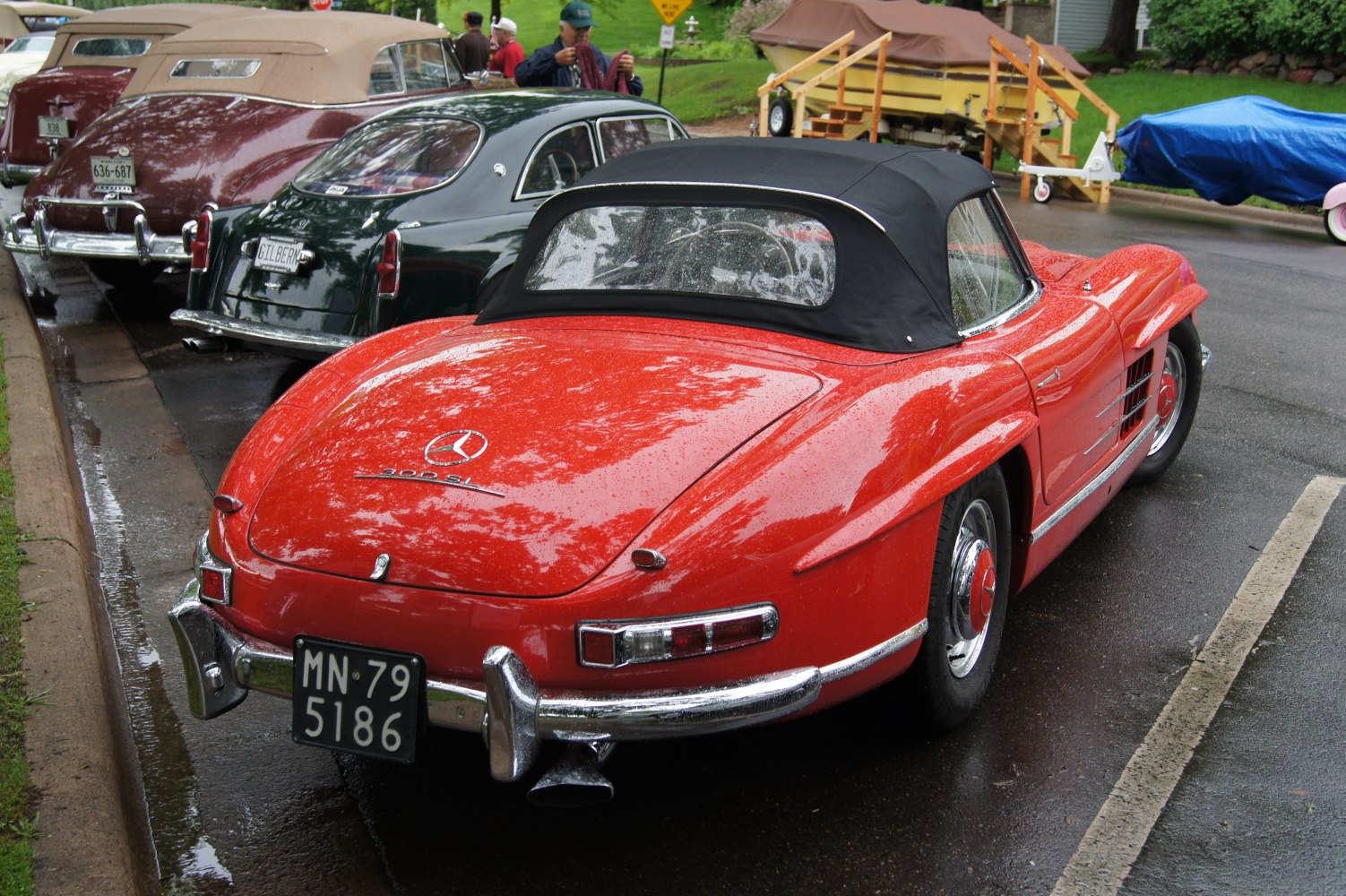 Vintage convertible roadster with black soft top and curved body