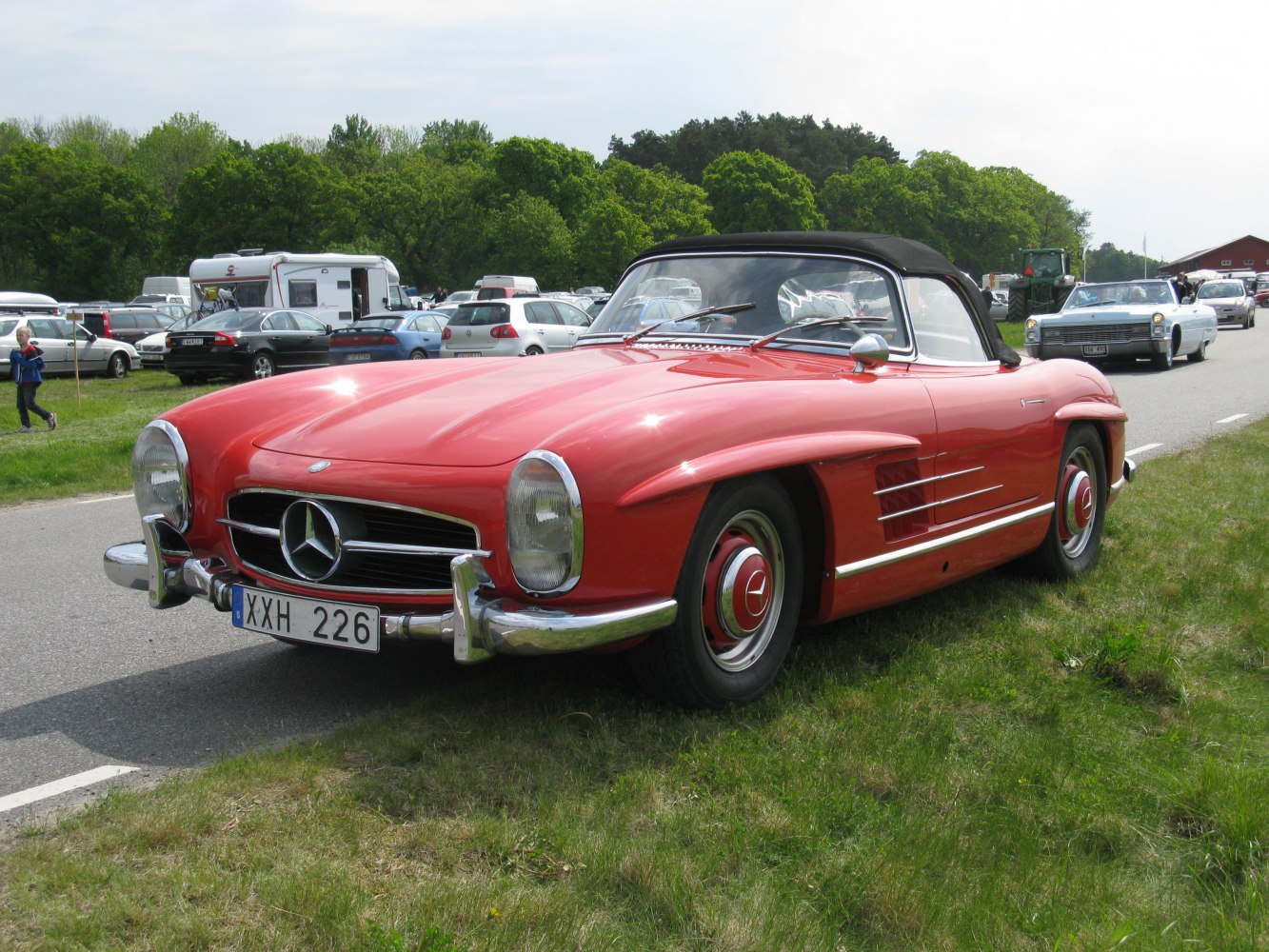 Red convertible with chrome accents and black soft top