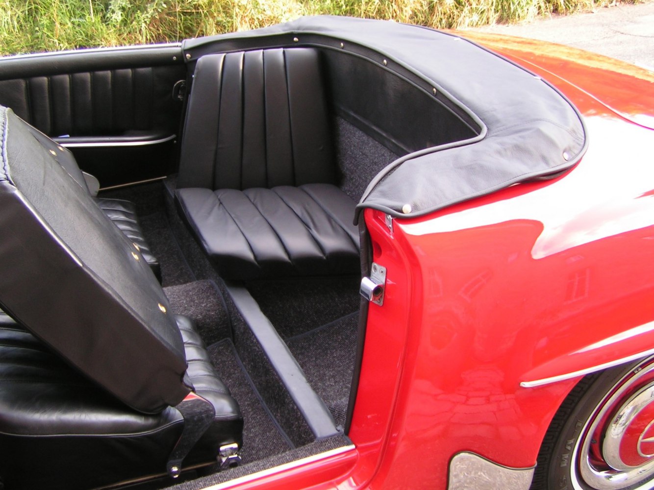 Black leather rear seating and convertible interior details with red exterior edge.