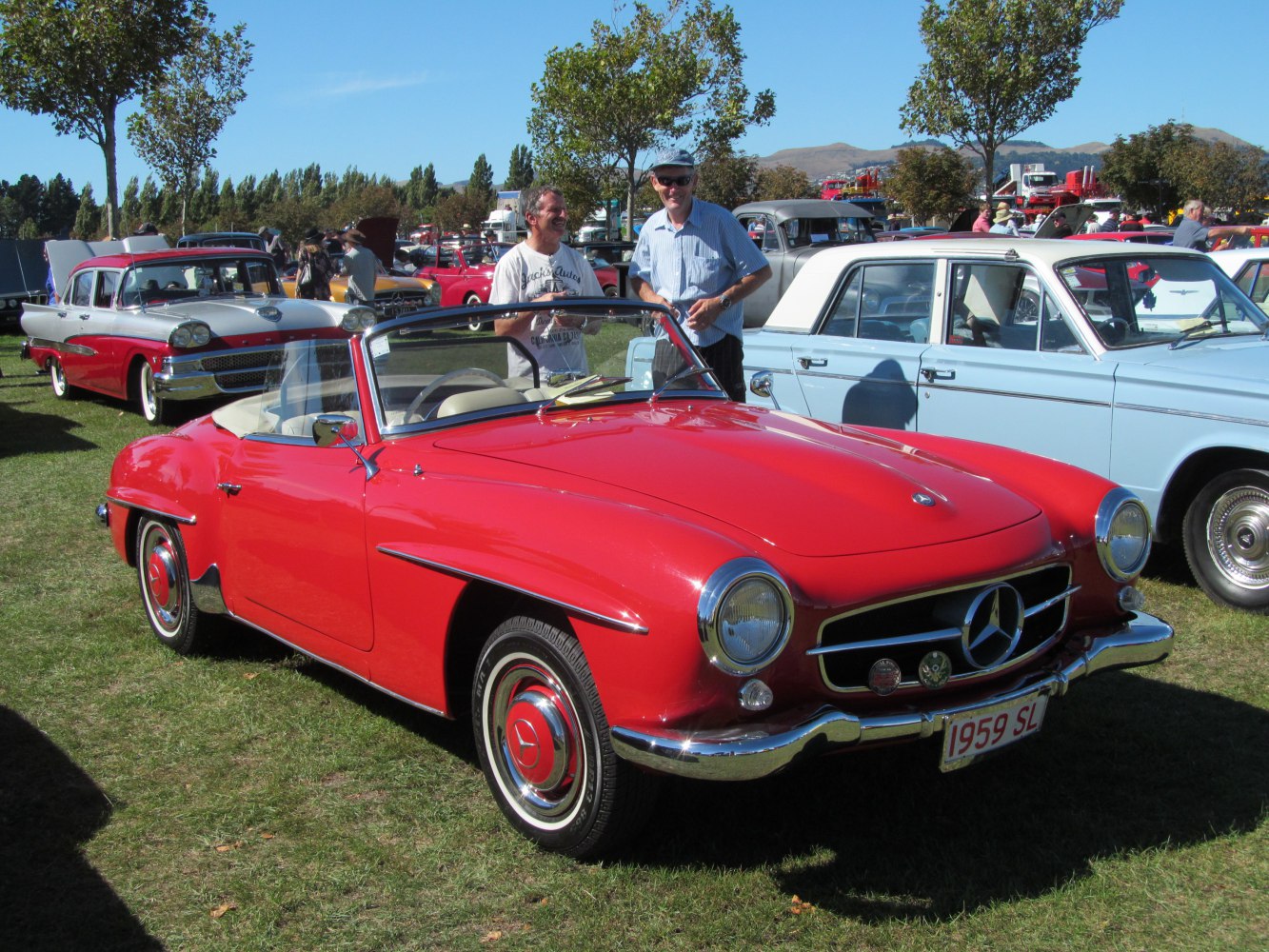 Red convertible roadster with chrome bumper and round headlights