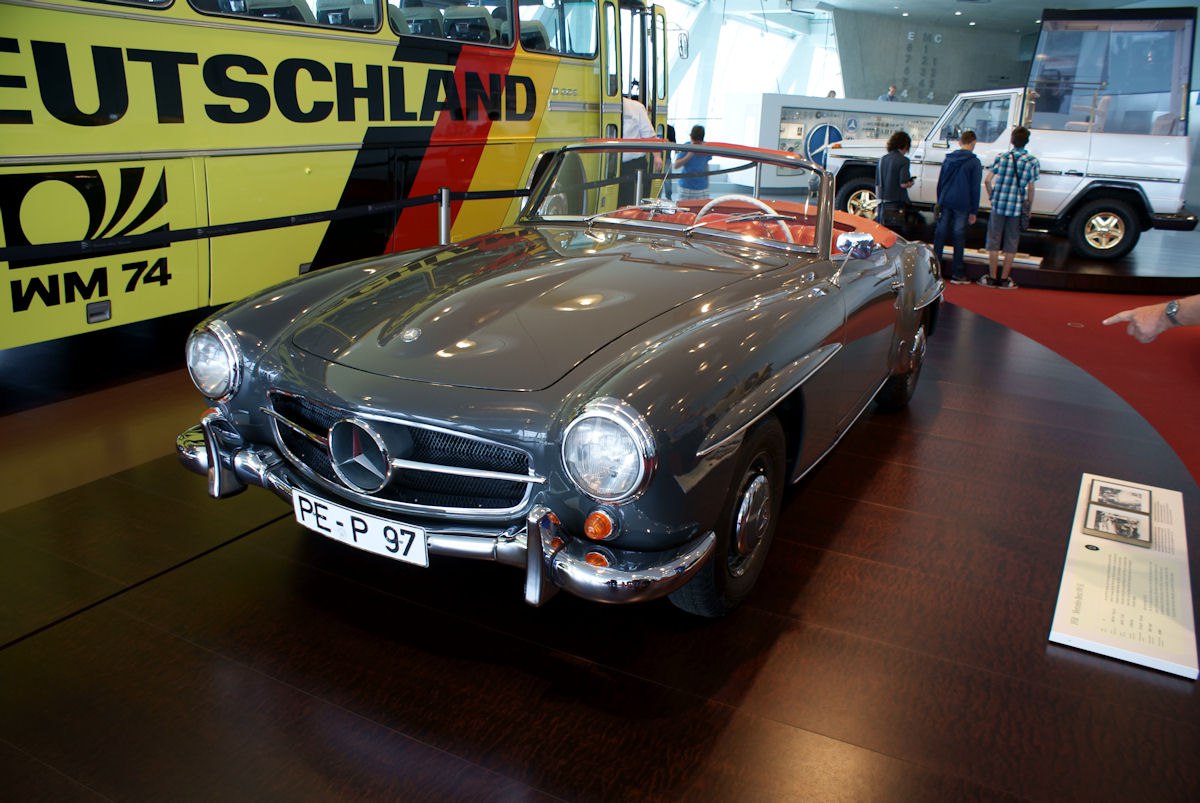 Classic vintage convertible with iconic grille and round headlights.