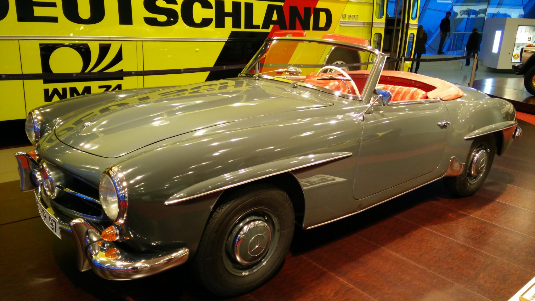 Classic convertible roadster with rounded headlights and chrome accents.