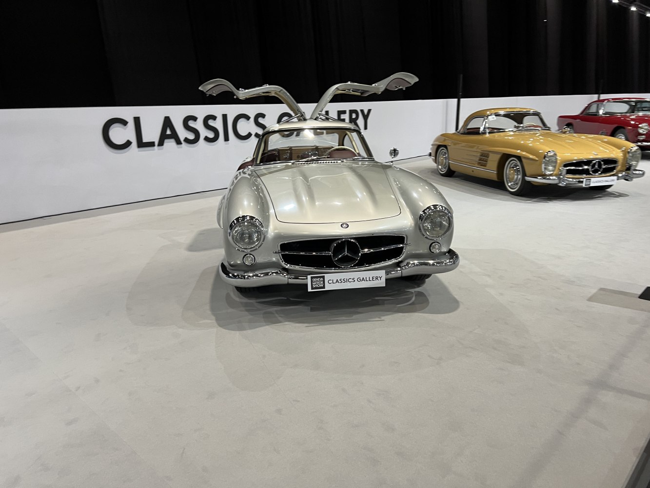 Silver vintage coupe with iconic gullwing doors and classic front grille