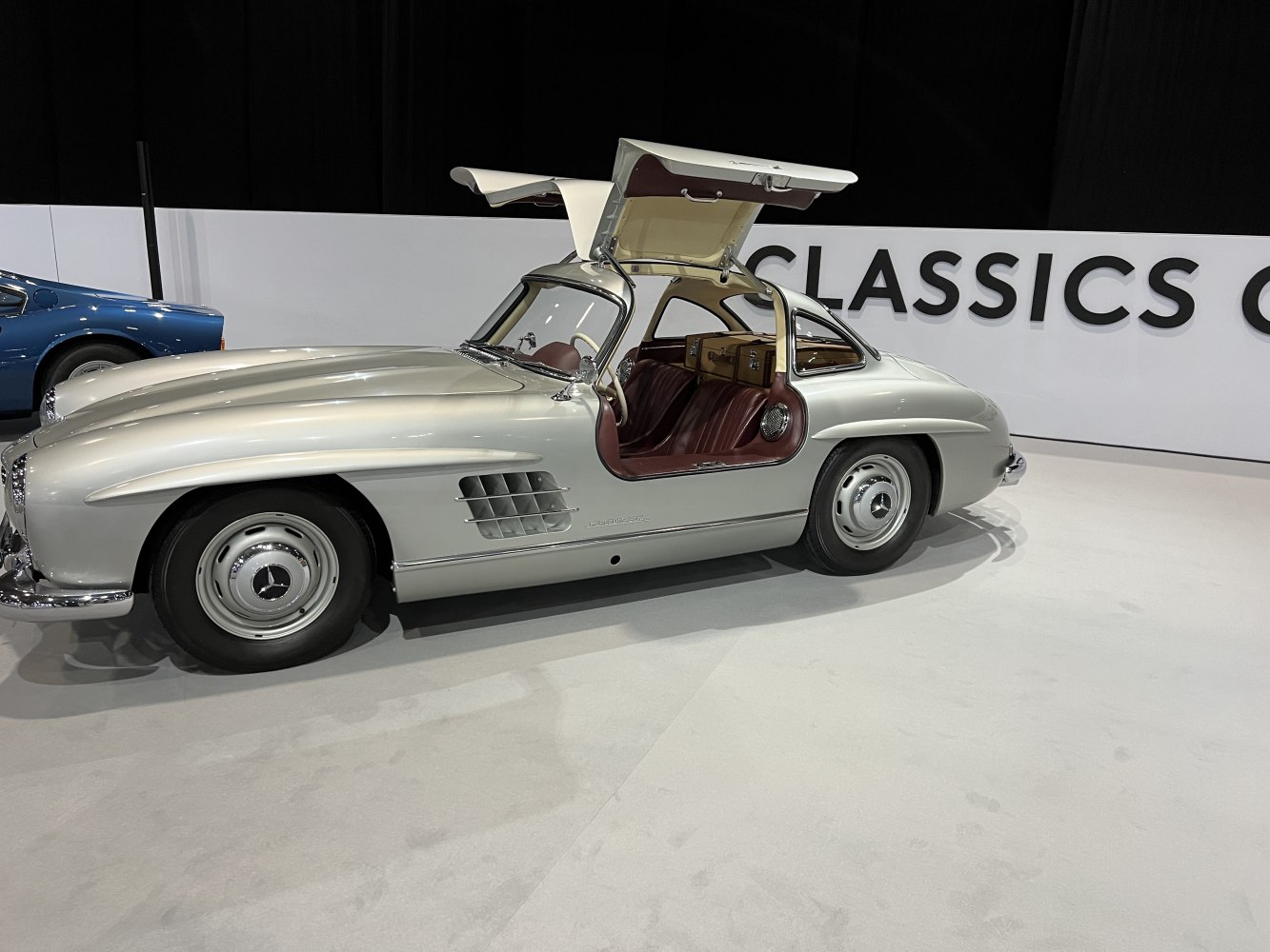 Classic silver coupe with gullwing doors open