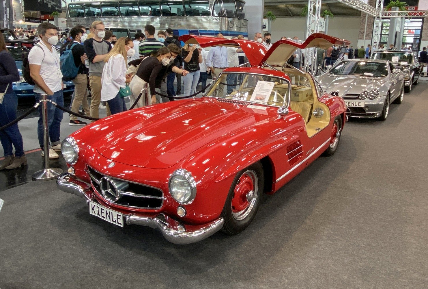 Vintage red coupe with iconic gullwing butterfly doors open at car show