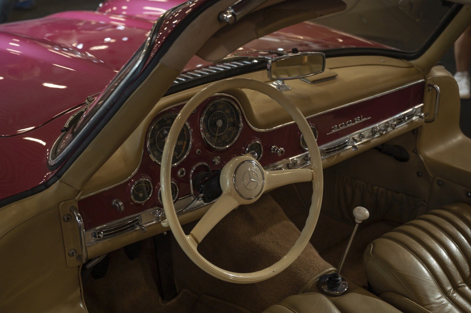 Vintage beige car interior with steering wheel and dashboard dials