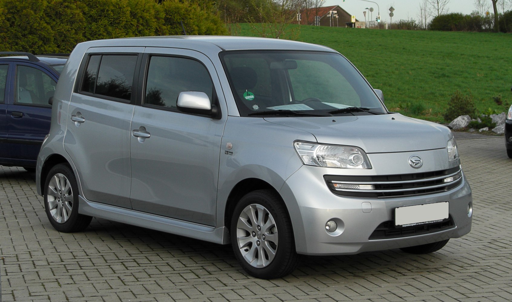 Compact silver hatchback with boxy shape and alloy wheels