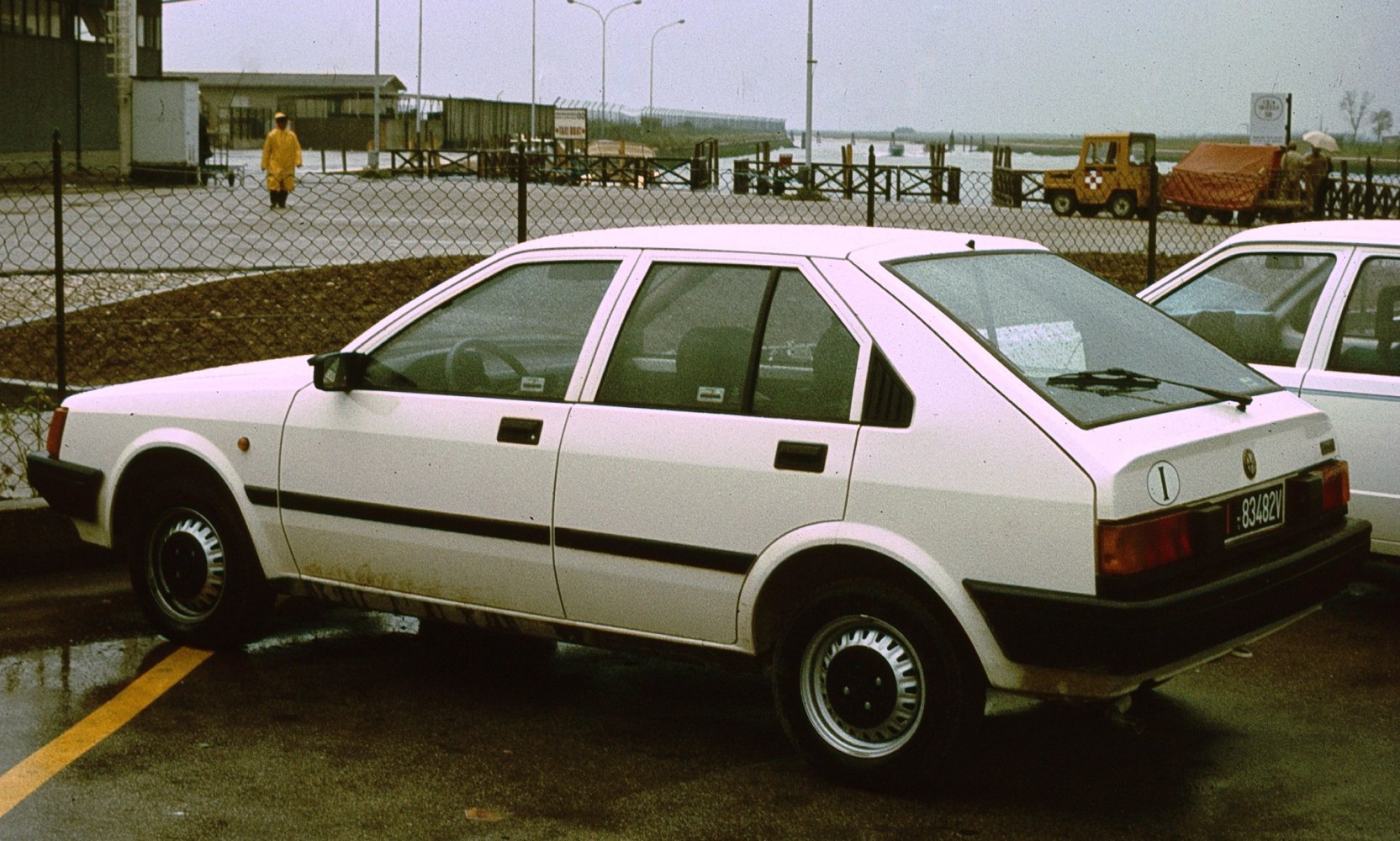 White boxy five-door hatchback side view