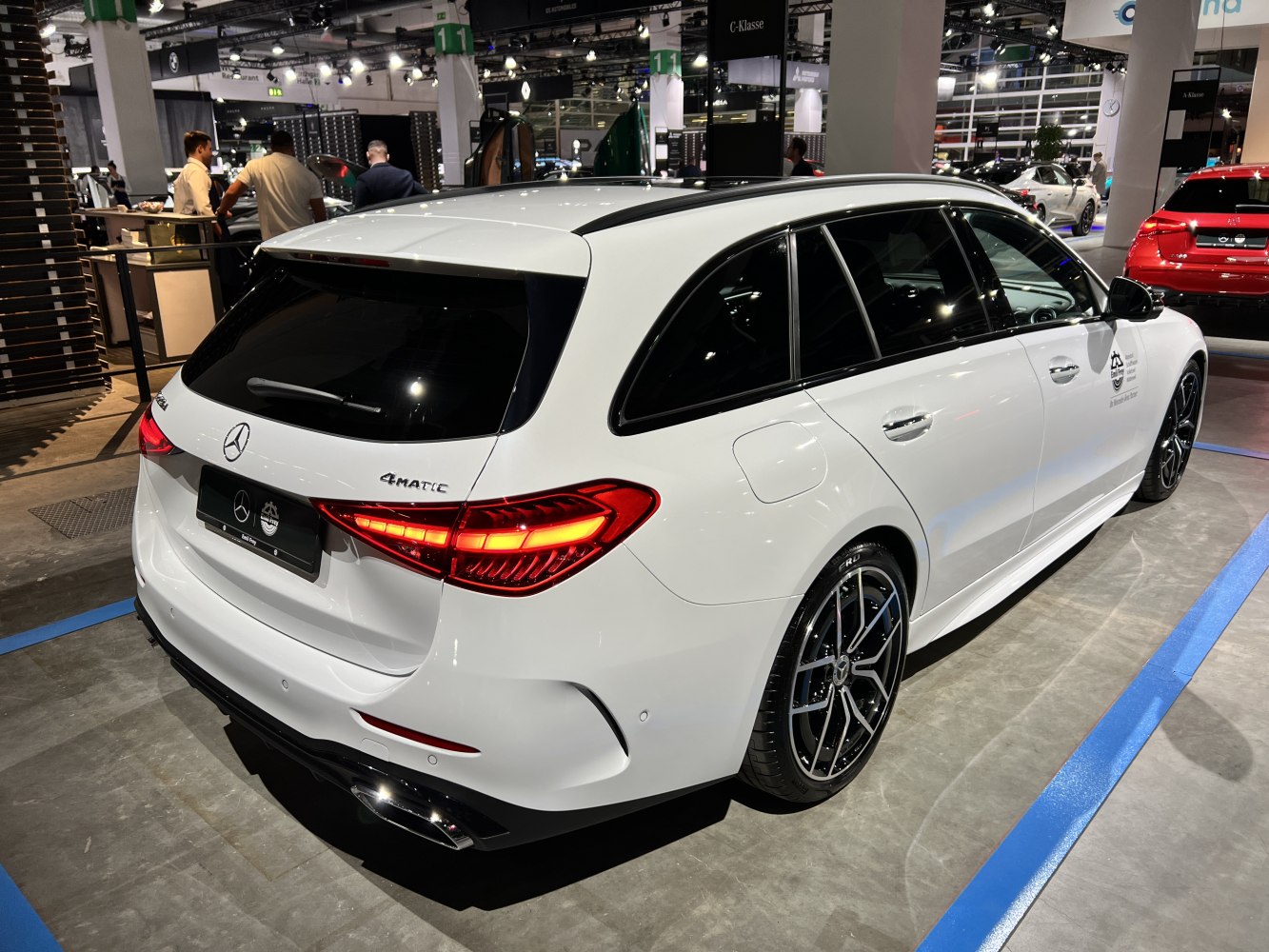 White station wagon with 4MATIC badge, sleek LED tail lights, and sporty alloy wheels.
