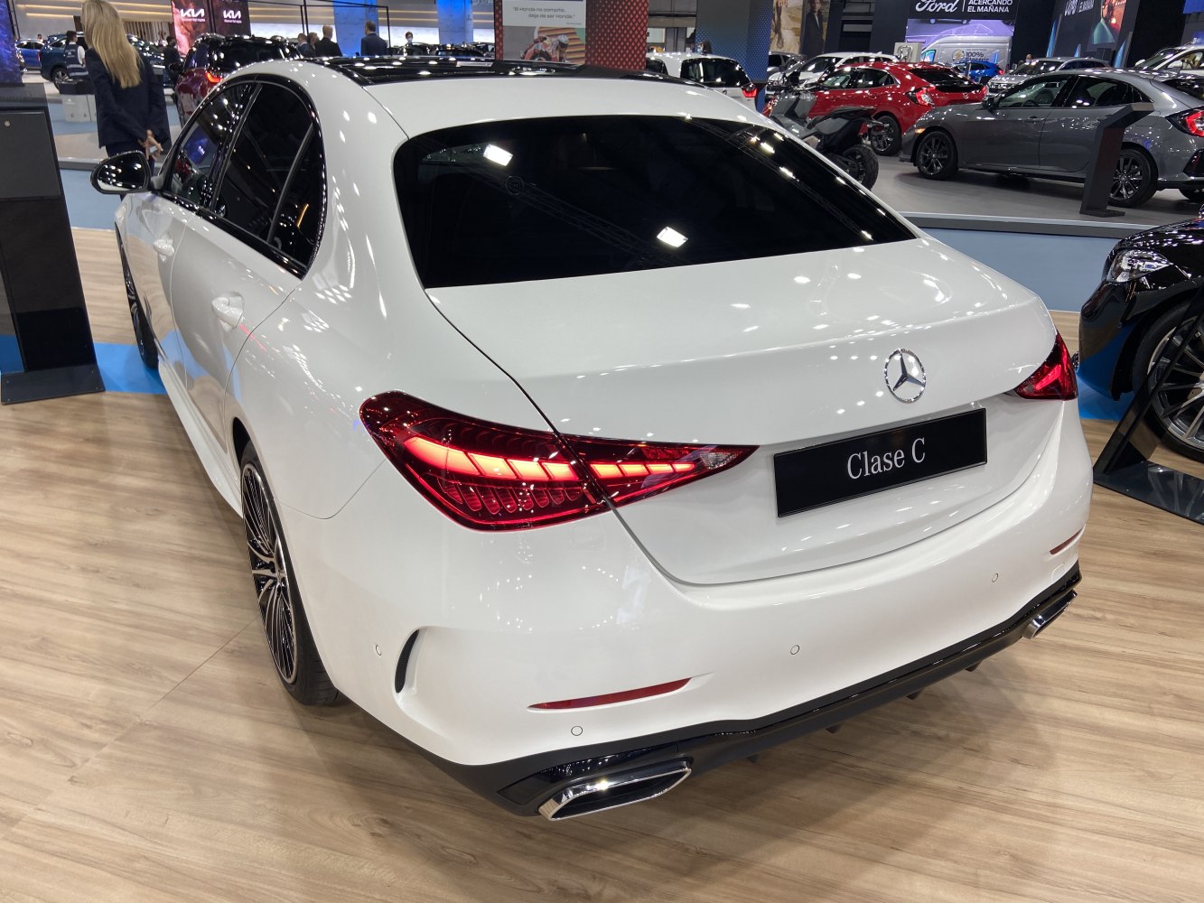 Rear view of a white sedan with LED tail lights and dual exhausts