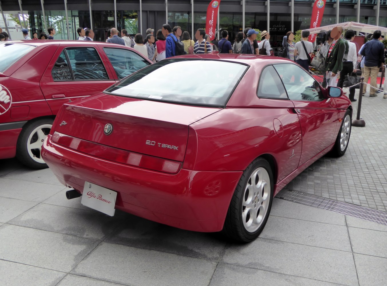 Rear view of red coupe with 2.0 T Spark badge and distinctive tail lights