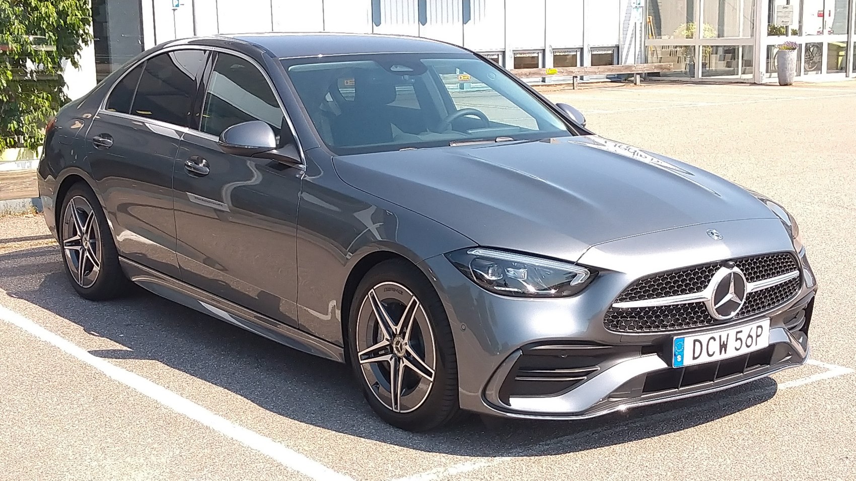 Front-side view of sleek sedan with angular headlights and alloy wheels