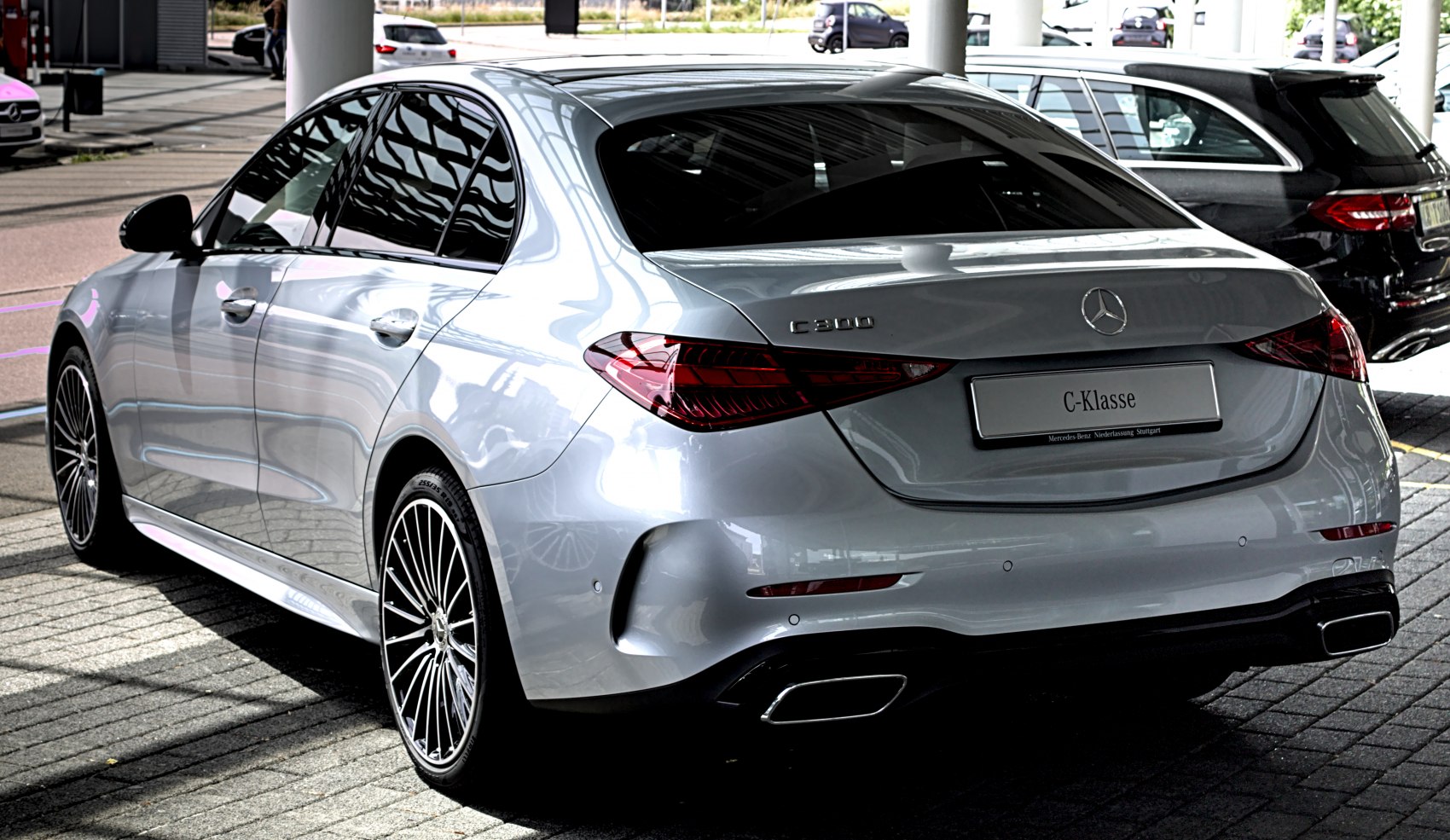 Sleek luxury sedan rear with LED taillights and dual exhausts