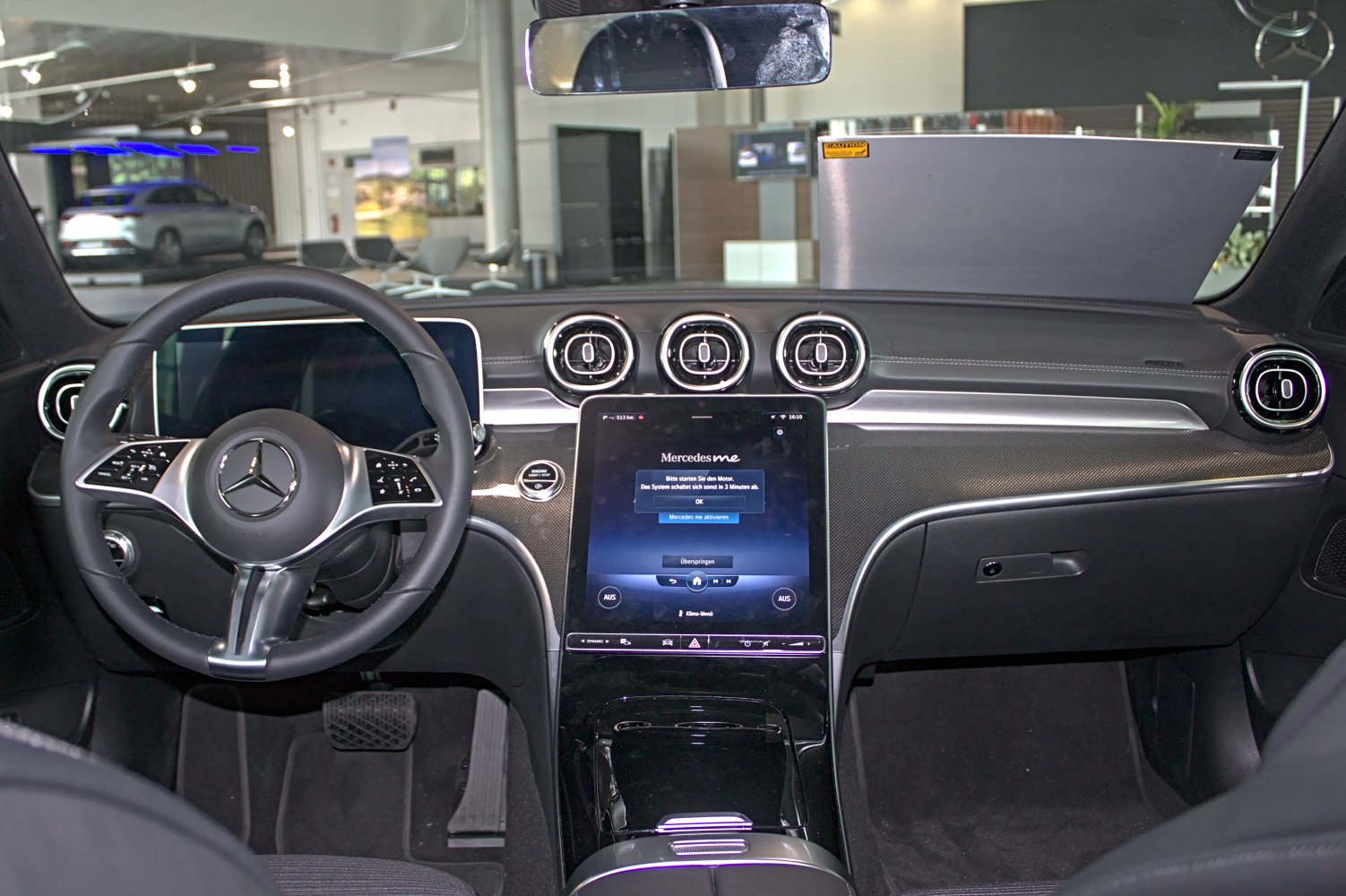 Digital touchscreen display and circular air vents in modern car interior