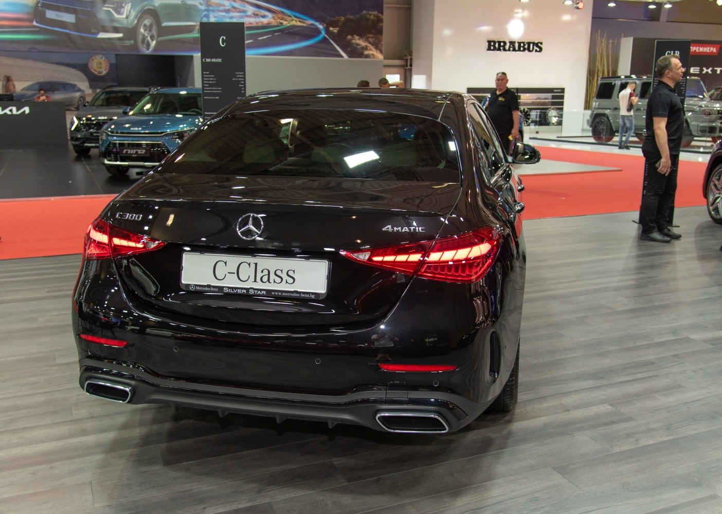 Rear view highlighting taillights and dual exhausts of a luxury sedan.
