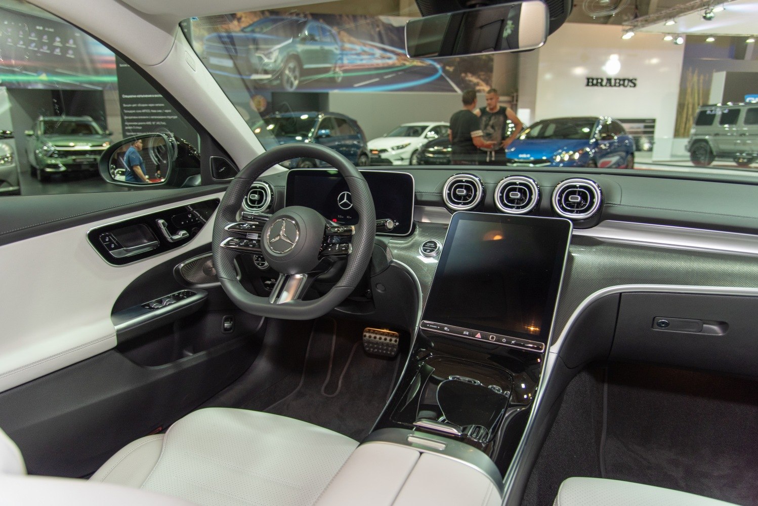 Luxury car interior with digital displays and triple circular vents