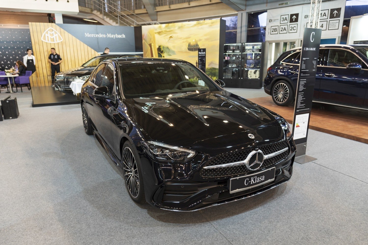 High-gloss black luxury sedan showing front grille and LED headlights