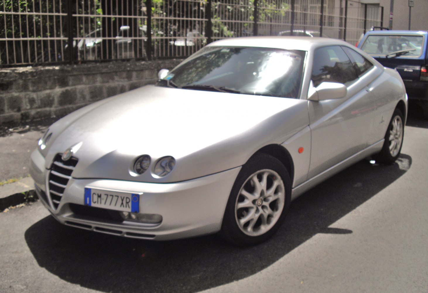 Silver coupe with distinctive four-headlight front and alloy wheels