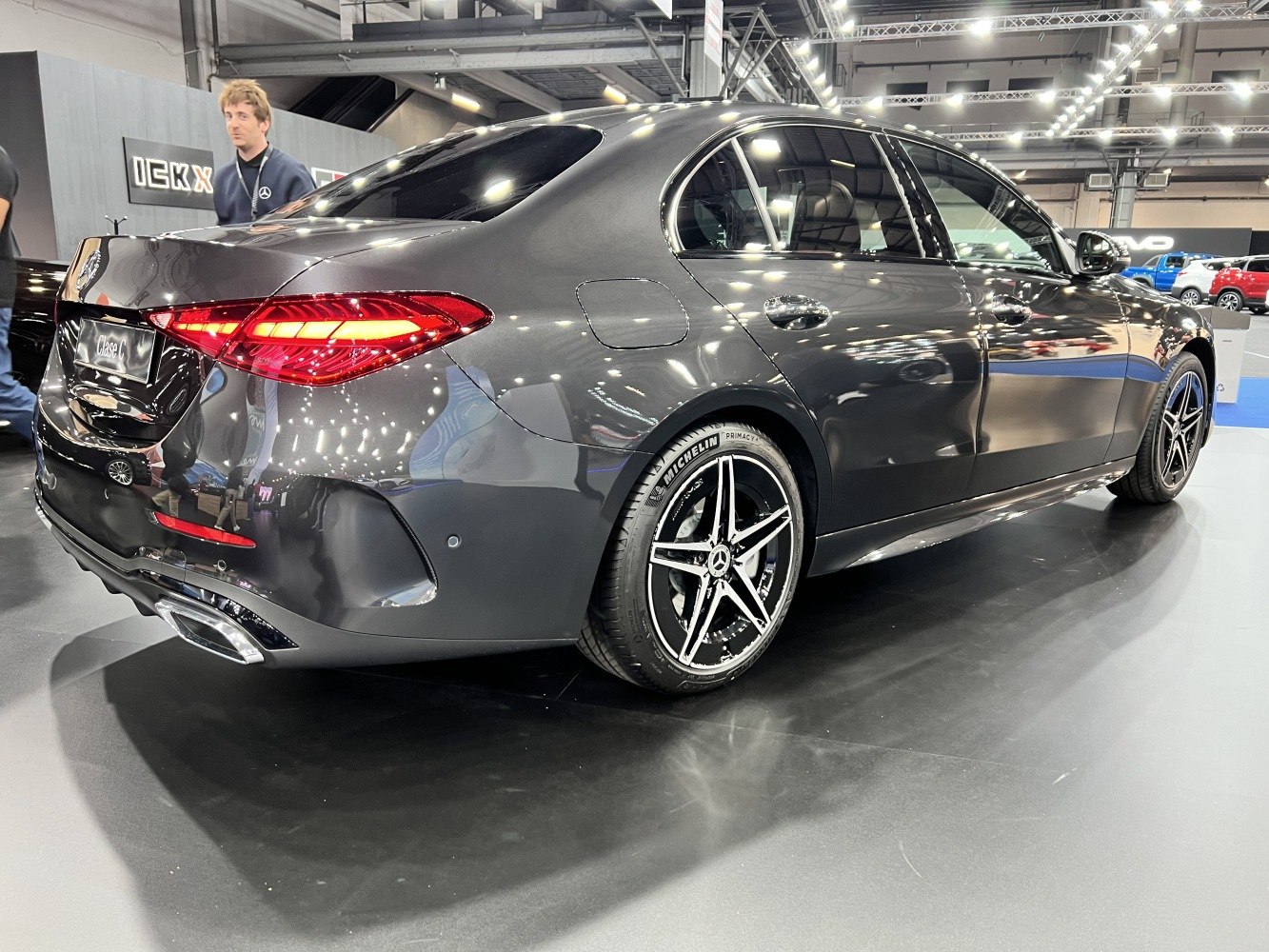 Sleek luxury sedan rear with LED tail lights and multi-spoke alloy wheels