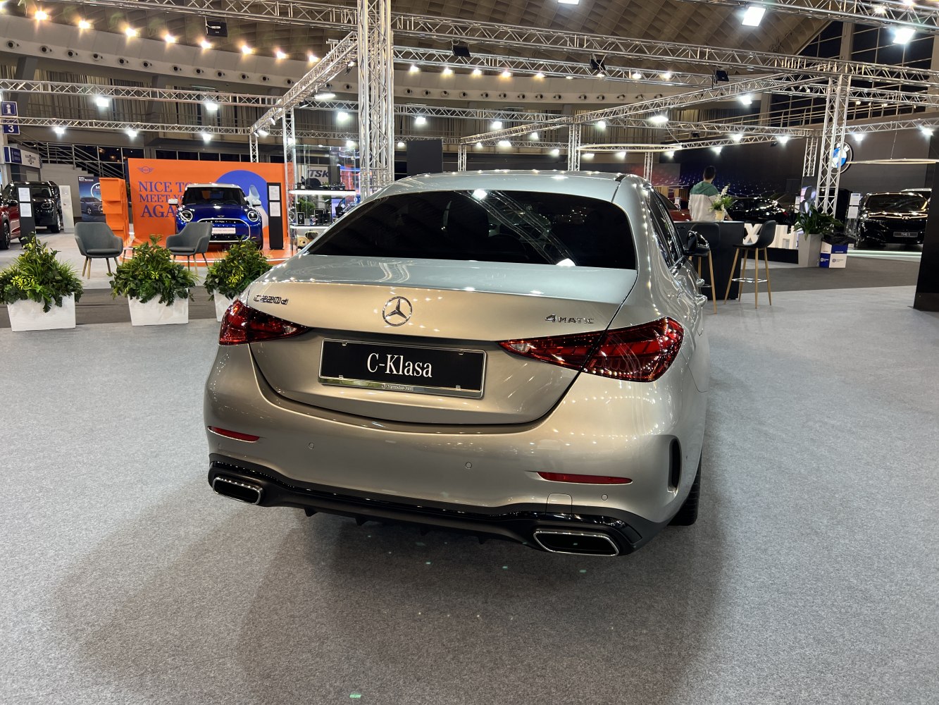 Rear view of silver sedan with dual exhausts and LED taillights