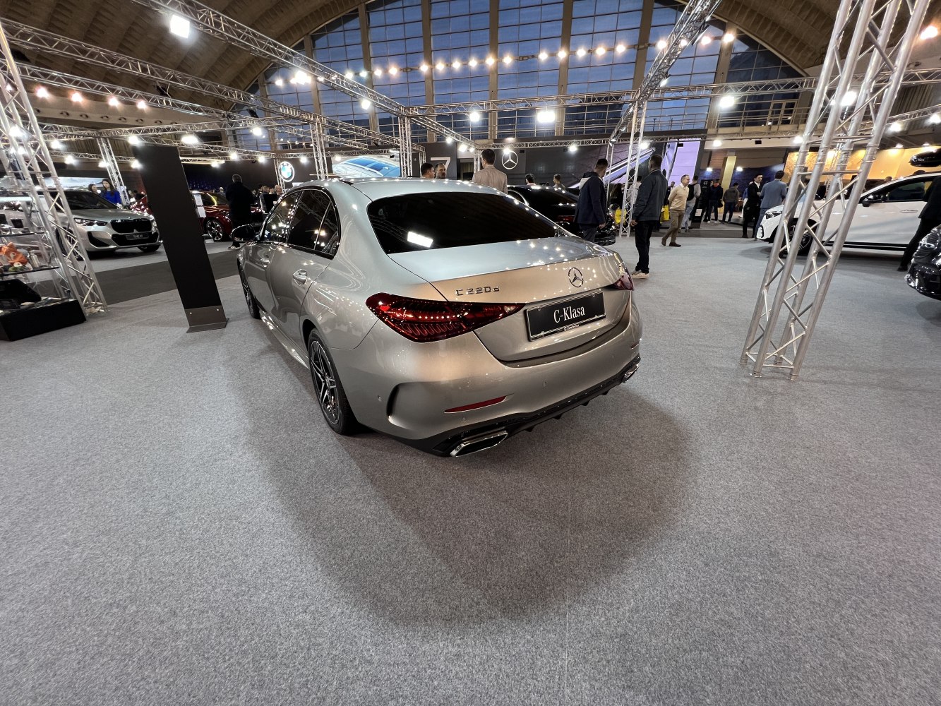 Rear view of sleek luxury sedan featuring taillights and dual exhaust tips.