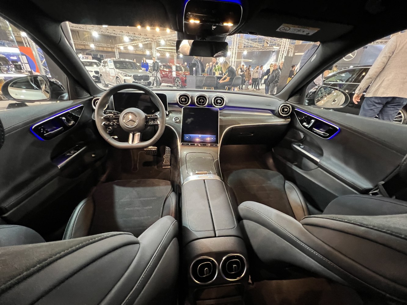 Luxury car interior with digital dashboard, ambient lighting, and touchscreen control