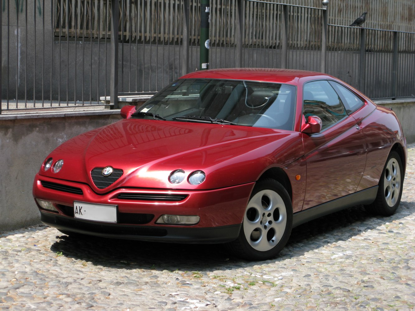 Front view showing quad round headlights and sleek coupe profile
