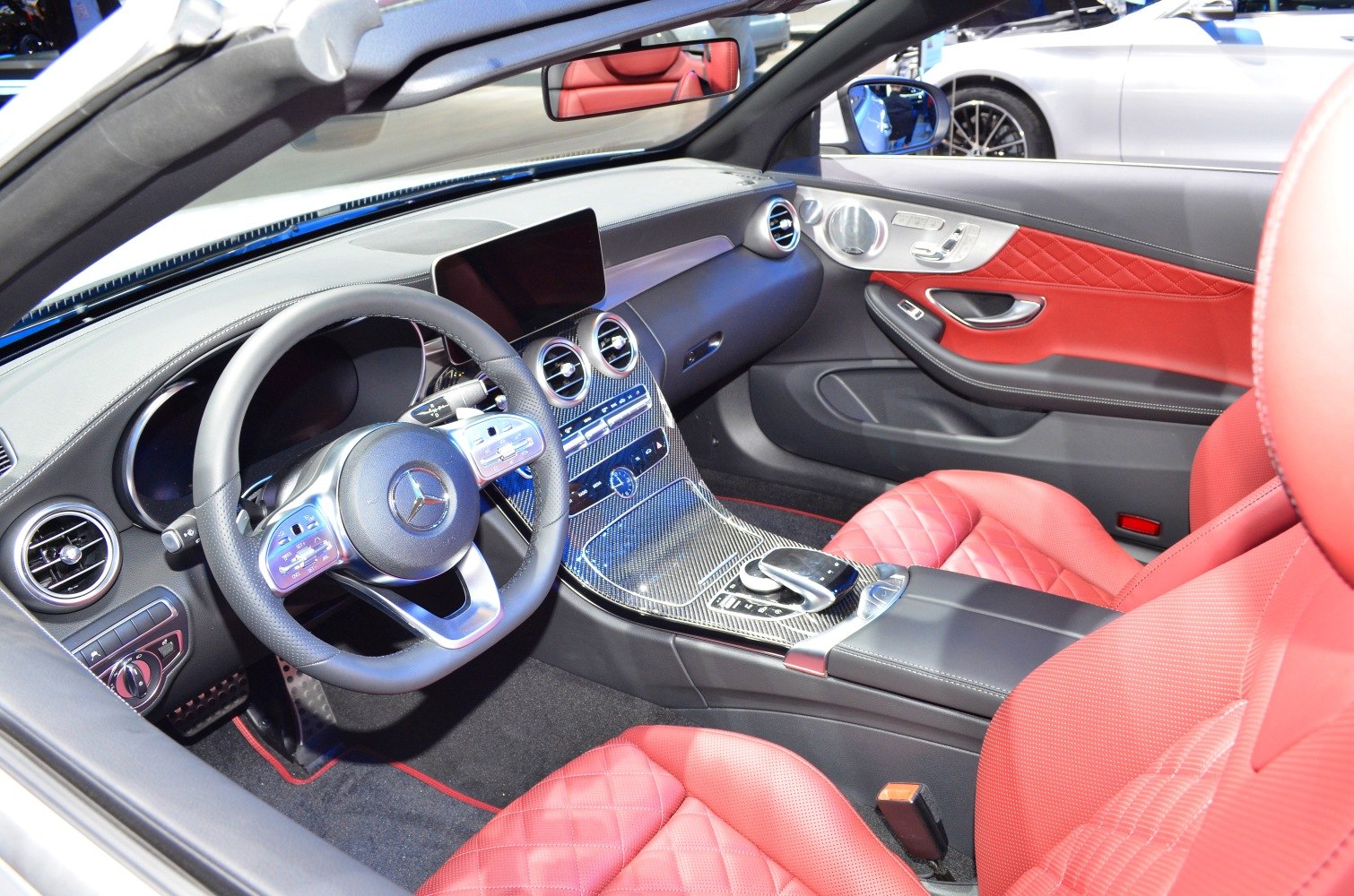Convertible cabin with red quilted leather seats and carbon fiber center console
