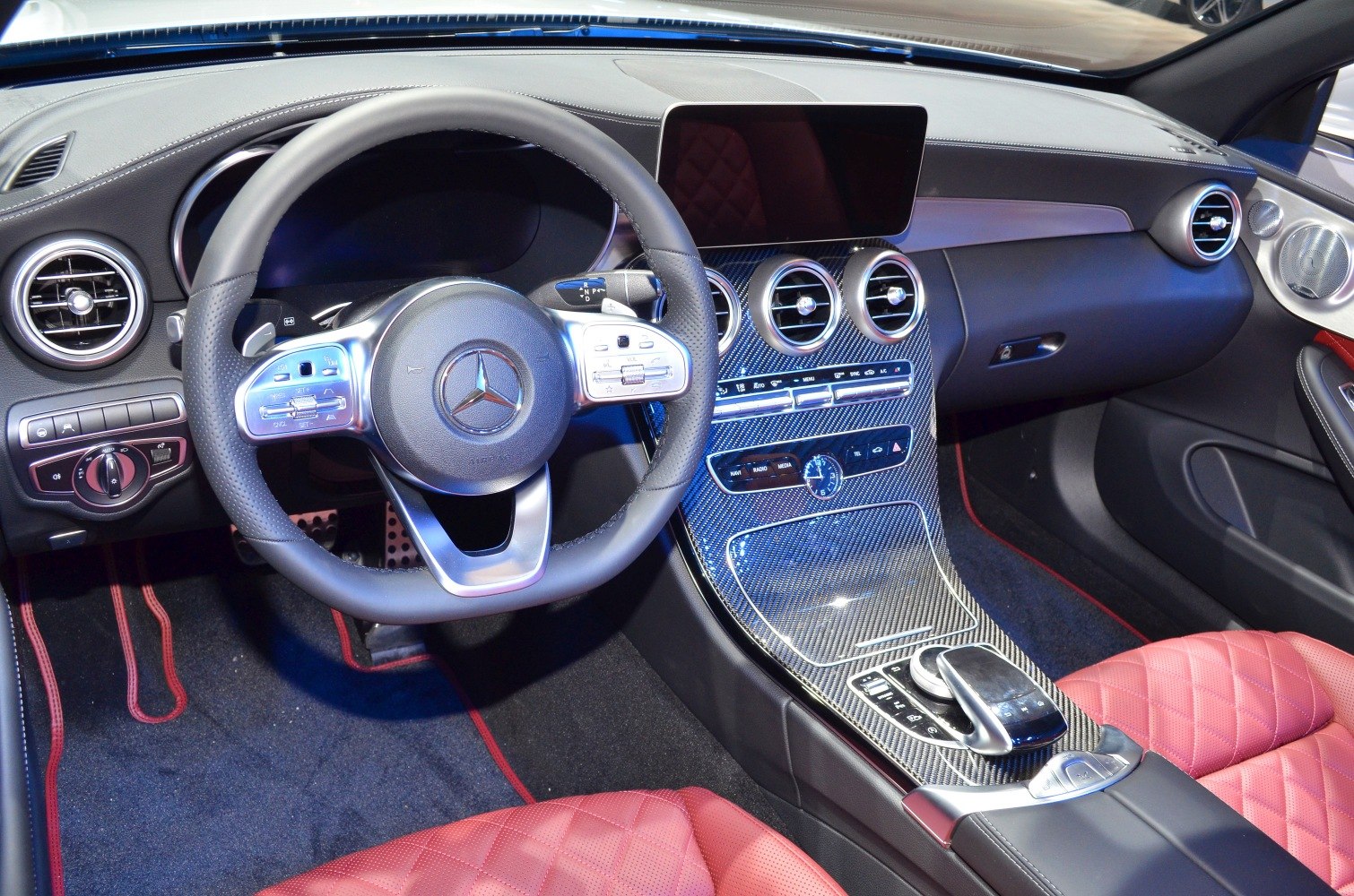 Luxury dashboard and steering wheel with carbon fiber trimming and red leather seats