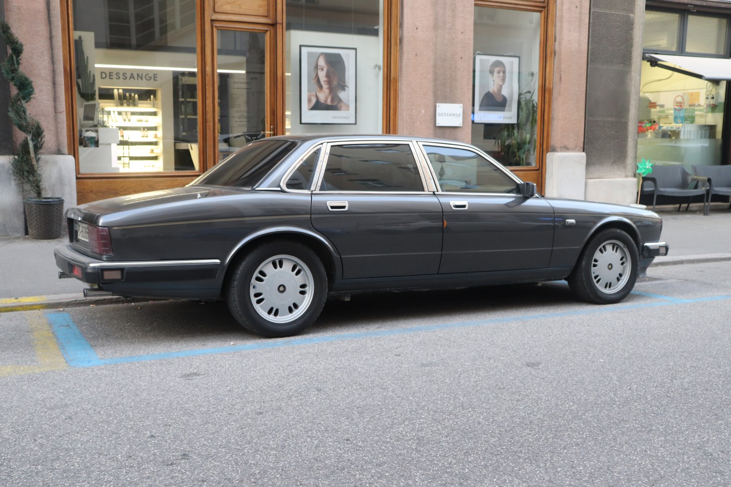 Vintage four-door luxury sedan with alloy wheels and chrome trim