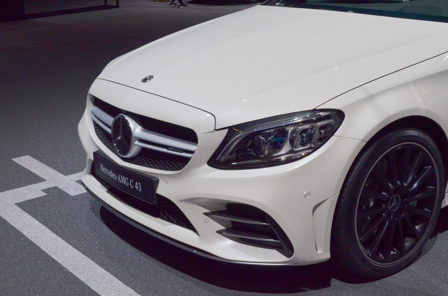 Front fascia with AMG grille, headlight, and black alloy wheel