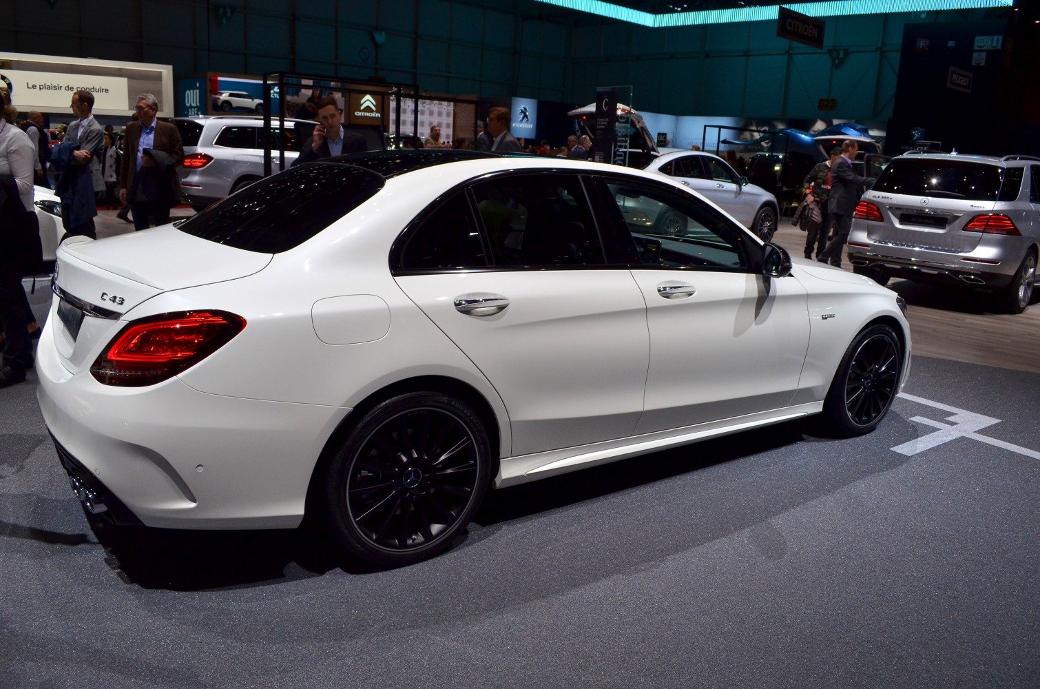 White luxury sedan side view with black rims and tinted windows