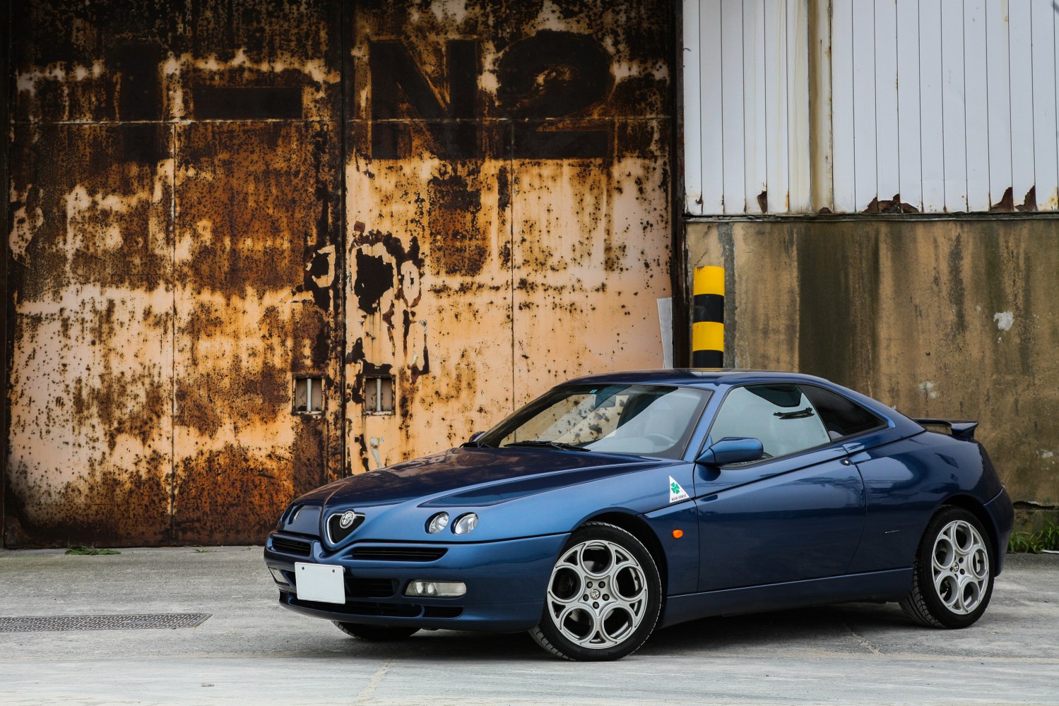 Sleek sports coupe with quad headlamps and distinctive alloy wheels