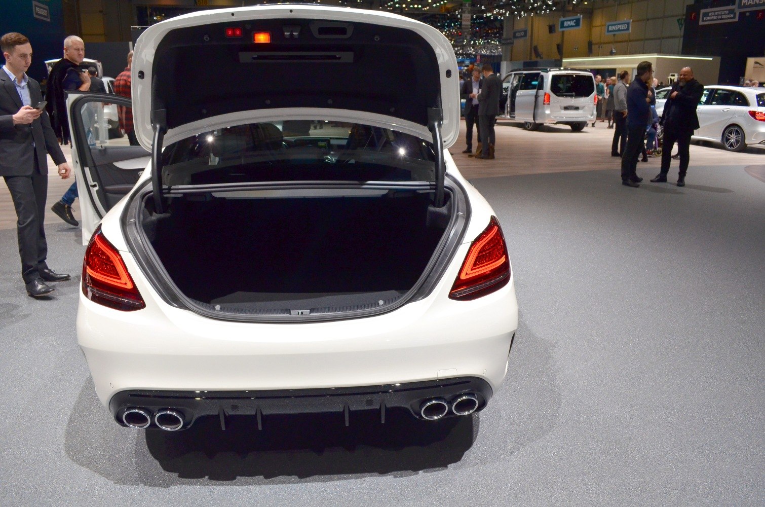 Open trunk with illuminated taillights and quad exhaust setup